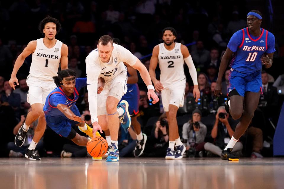 Xavier forward Jack Nunge (24) fights for a loose ball with DePaul guard Philmon Gebrewhit (5) during the second round of the Big East conference tournament, Thursday, March 9, 2023, at Madison Square Garden in New York.