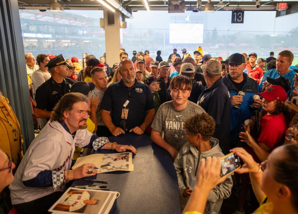 WORCESTER - As rain falls on the field at Polar Park, fans line up to meet Red Sox legend Wade Boggs on the concourse Thursday, August 10, 2023.
