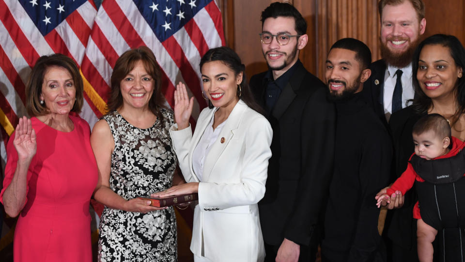 Nancy Pelosi, left, swears in Rep. Alexandria Ocasio-Cortez, D-N.Y. (Photo: Saul Loeb/Getty Images)