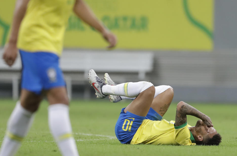 Brazil's Neymar lies on the pitch after being fouled during a friendly match against Qatar in Brasilia, Brazil, Wednesday, June 5, 2019. Brazil and Qatar are preparing for the Copa America which runs from June 14 until July 7 in Brazil. (AP Photo/Andre Penner)