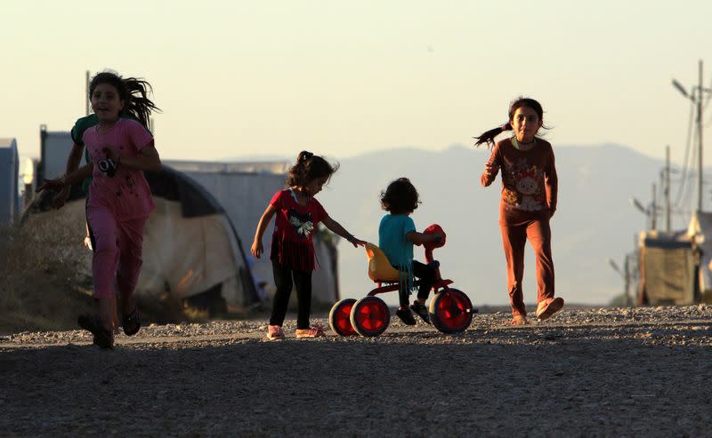 FILE PHOTO: Displaced Iraqi children from the minority Yazidi sect, who fled the Iraqi town of Sinjar, play at the Khanki camp on the outskirts of Dohuk province