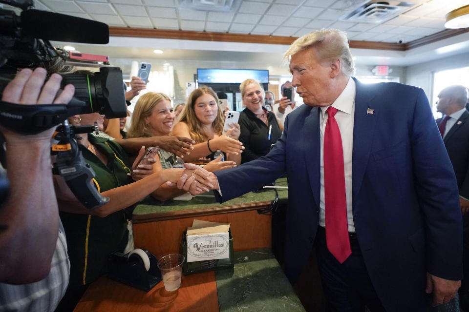 FILE - Former President Donald Trump greets supporters at Versailles restaurant on Tuesday, June 13, 2023, in Miami. Trump appeared in federal court Tuesday on dozens of felony charges accusing him of illegally hoarding classified documents and thwarting the Justice Department's efforts to get the records back. (AP Photo/Alex Brandon, File)