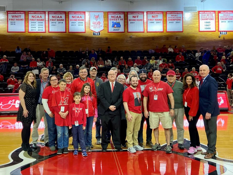 Marist College women's basketball coach Brian Giorgis celebrated in his final home game before retirement, is joined by his family during a ceremony before their Feb. 25, 2023 game. Among the group was Giorgis' siblings John, Dave, Mary, Anne and Margaret, and Marist athletic director Tim Murray.