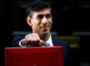 Britain's Chancellor of the Exchequer Rishi Sunak poses outside his office in Downing Street in London