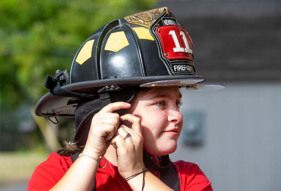 Cydney Marx straps on her helmet during a training session for the Newburgh Volunteer Fire Department Saturday, Sept. 16, 2023.