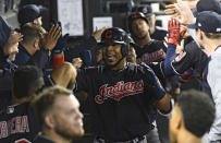 FILE - In this Sept. 26, 2018, file photo, Cleveland Indians' Edwin Encarnacion, center, celebrates in the dugout after he hit a three run home run against the Chicago White Sox during the fourth inning of a baseball game in Chicago. Encarnacion has been traded to Seattle and first baseman Carlos Santana has returned to the Indians in a three-team deal that also involved Tampa Bay. The Rays got infielder Yandy Diaz and minor league right-hander Cole Slusser from Cleveland. The Indians also acquired first baseman Jake Bauers. The swap came Thursday, Dec. 13, 2018, at the close of the winter meetings. (AP Photo/Matt Marton, File)