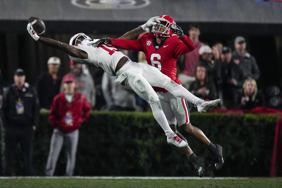 Mississippi wide receiver Dayton Wade (19) makes a one-handed catch as Georgia defensive back Daylen Everette (6) defends during the second half of an NCAA college football game, Saturday, Nov. 11, 2023, in Athens, Ga. (AP Photo/John Bazemore)