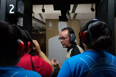 Gun Central general manager instructs a group of three friends who decided to learn how to shoot in El Paso