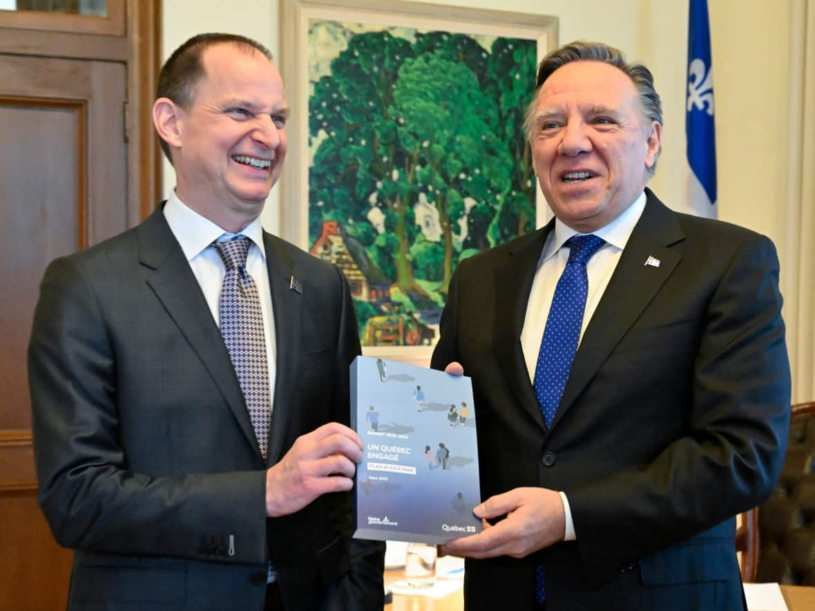 Quebec Finance Minister Eric Girard, left, and Quebec Premier François Legault earlier today. Girard says worldwide economic uncertainty has made it more probable that Quebec will have to dip into a contingency fund. (Jacques Boissinot/The Canadian Press - image credit)