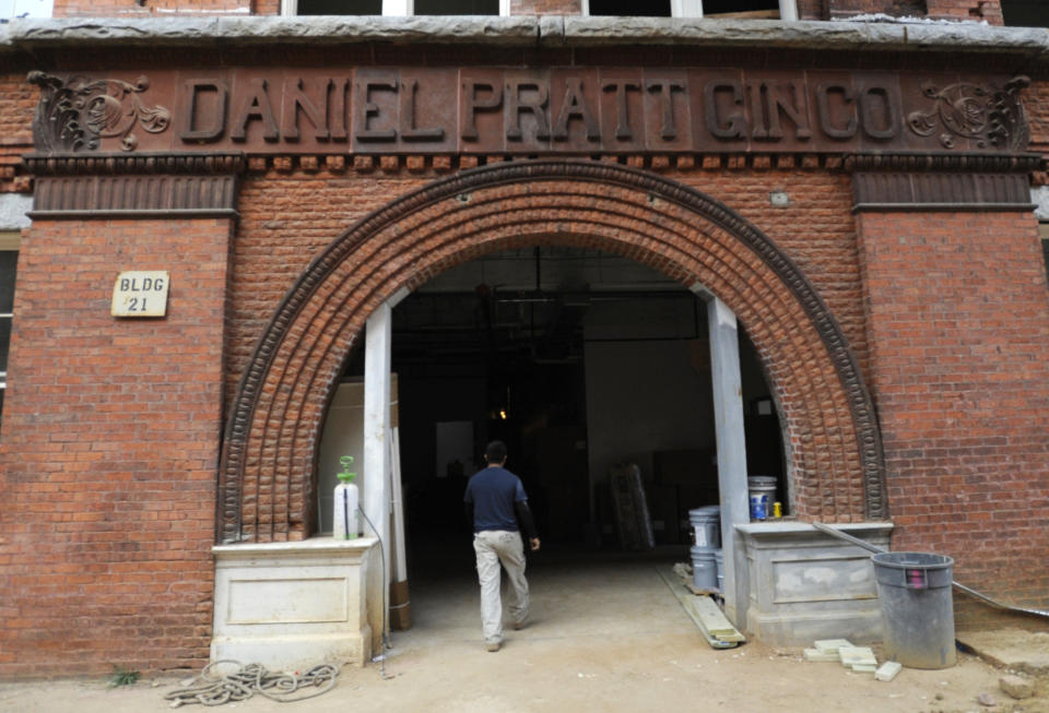 A man enters an old cotton gin factory that is being renovated into apartments in Prattville, Ala., on Thursday, Nov. 10, 2022. The project demonstrates the difficulty of telling complicated U.S. history in 2022. (AP Photo/Jay Reeves)