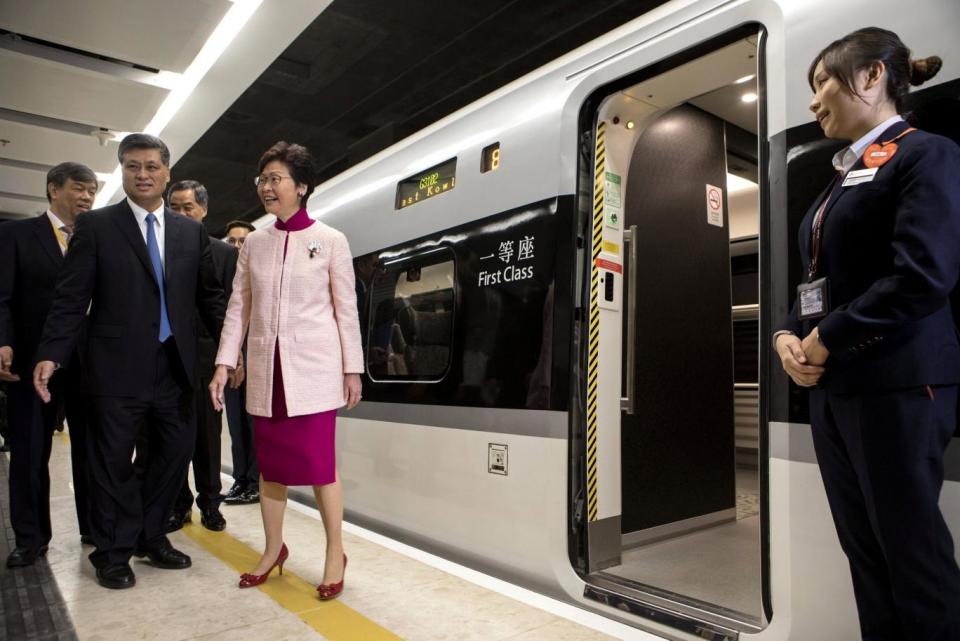 Ma Xingrui, governor of Guangdong Province, and Carrie Lam, Hong Kong's chief executive, stand next to one of the new trains (REUTERS)