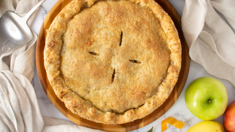 pie on table with apples