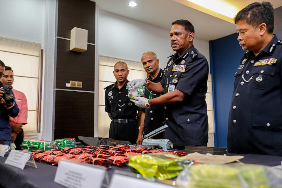 Penang CPO Datuk T. Narenasagaran (middle) shows some of the drugs seized during a press conference at the Penang Police Contingent in George Town May 23, 2019. — Picture by Sayuti Zainudin