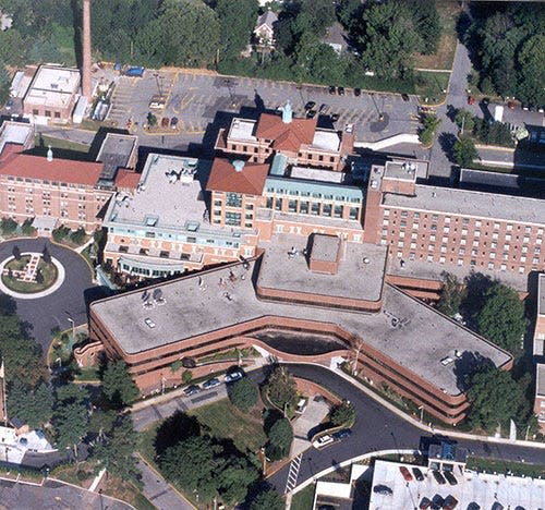 Holy Name Hospital in Teaneck transformed over multiple renovations, including the 1993 addition seen here. The new parking would be added near the tree-covered area at the top of the photo.