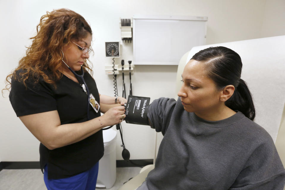 A woman has her blood pressure taken during a visit to the WellSpace community clinic in Sacramento, Calif. (AP Photo/Rich Pedroncelli)