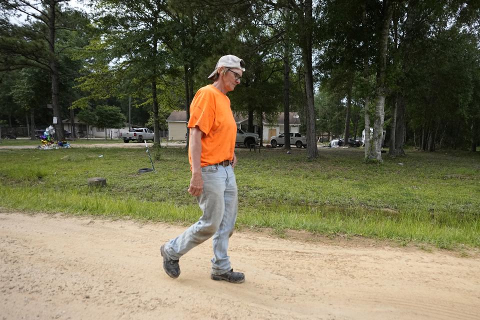 Shawn Crawford walks past the scene Tuesday, May 2, 2023, where a mass shooting occurred last week on her street, in Cleveland, Texas. Five people were killed in the mass shooting when the suspected gunman, Francisco Oropeza, allegedly shot his neighbors after they asked him to stop firing off rounds in his yard. (AP Photo/David J. Phillip)