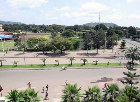 Pedestrians walk on an empty street during a clash between the Sidama youth and a securities after they declared their own region in Hawassa