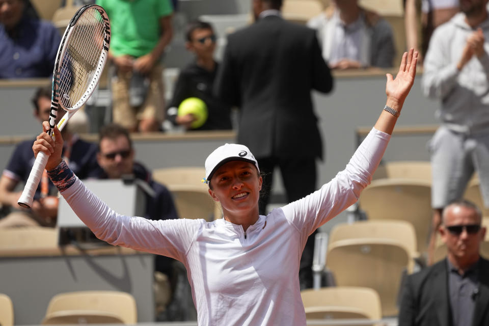 Poland's Iga Swiatek celebrates winning her third round match Montenegro's Danka Kovinic in two sets, 6-3, 7-5, at the French Open tennis tournament in Roland Garros stadium in Paris, France, Saturday, May 28, 2022. (AP Photo/Michel Euler)