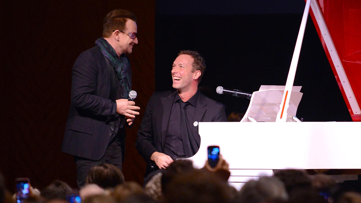  Bono (L) and Chris Martin perform on stage at Sotheby's during the 2013 (RED) Auction Celebrating Masterworks Of Design and Innovation on November 23, 2013 in New York City. 