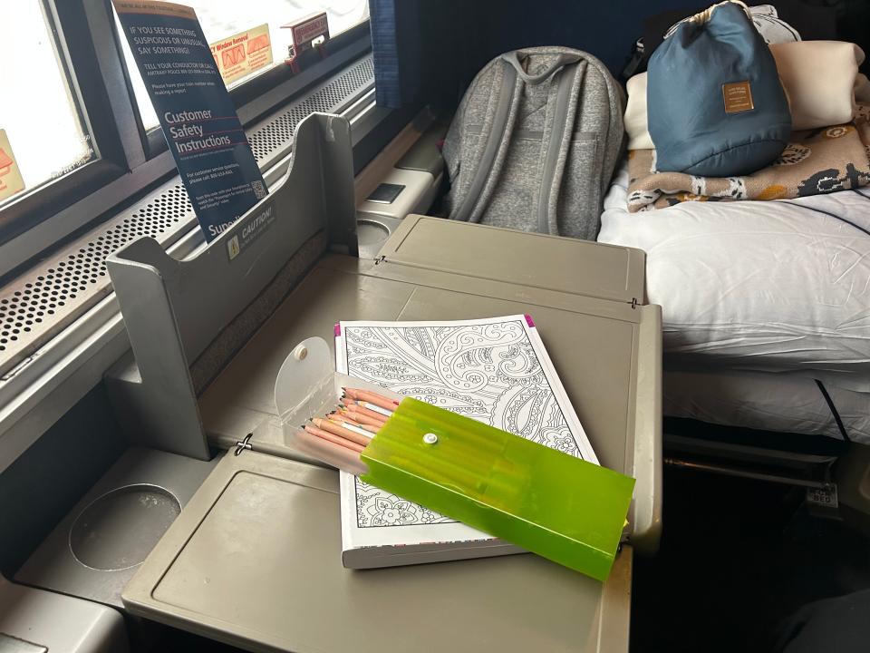 A table that pulls out between two chairs in the Amtrak roomette.