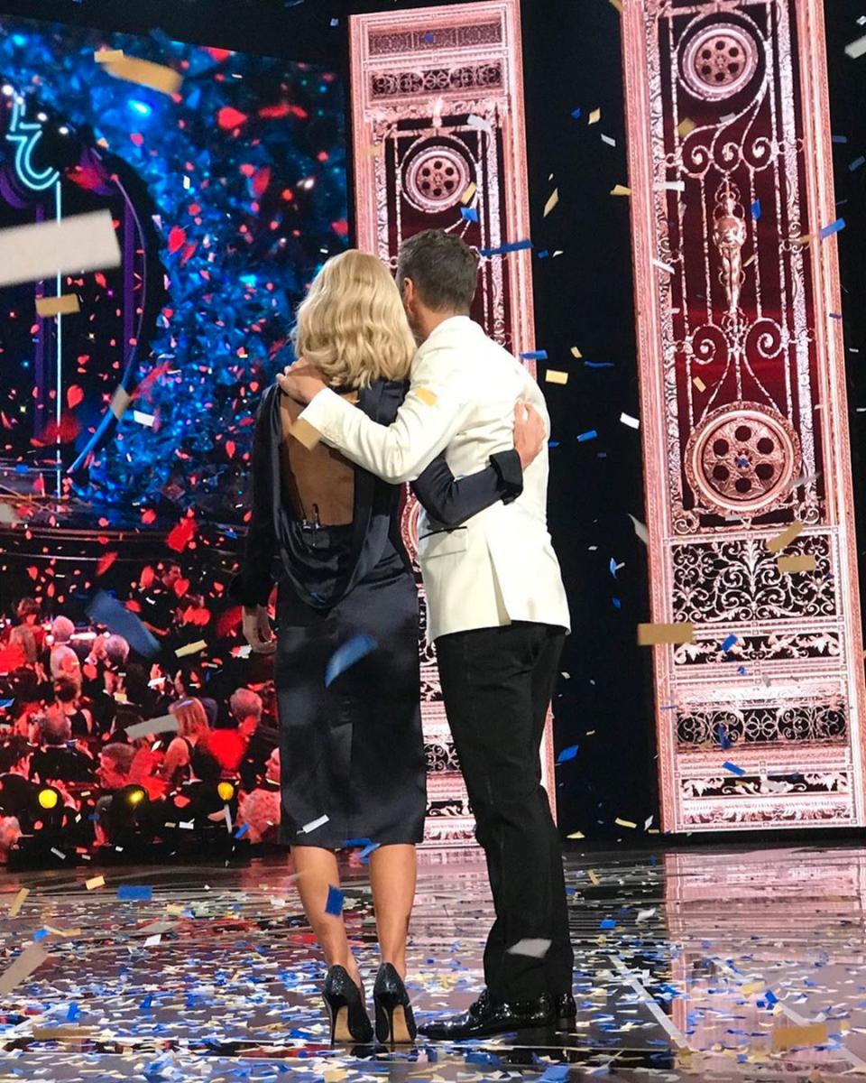 Kelly Ripa and Ryan Seacrest shot from behind on stage