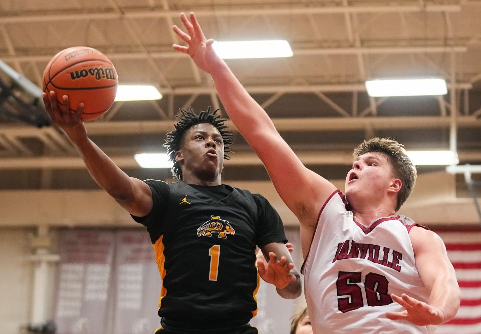 Avon Orioles guard Rohan Pearson (1) attempts to score against Danville's center Evan Lawrence (50) on Saturday, Jan. 6, 2024, during the game at Danville Community High School in Danville.