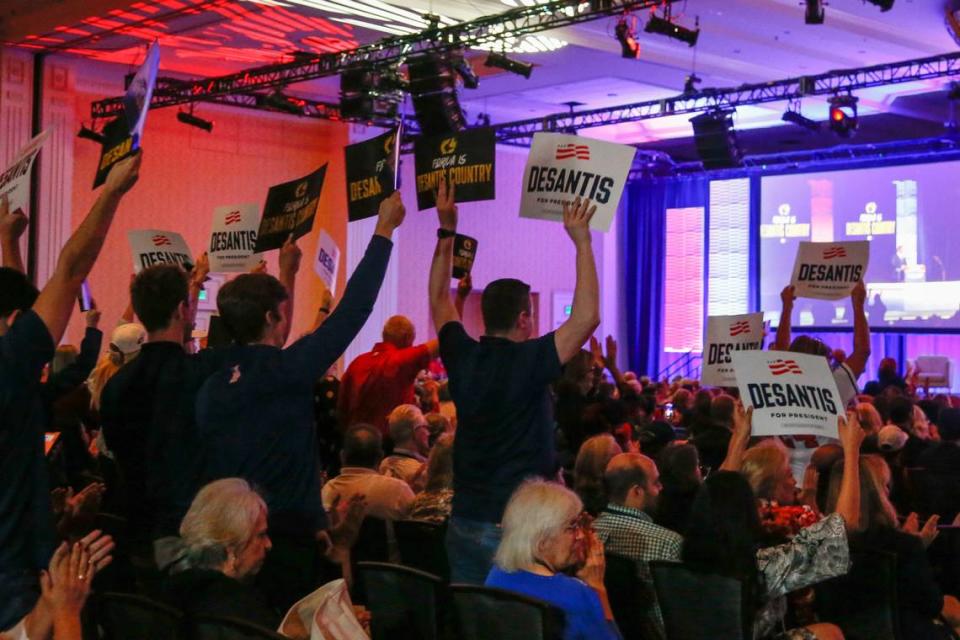 Supporters hold up a signs in support of Ron DeSantis for President during the Florida Freedom Summit on Saturday, Nov. 4, 2023 in Orlando.