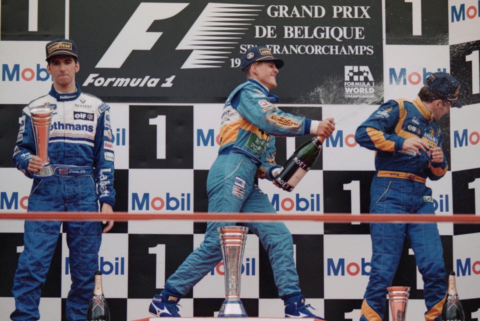 Michael Schumacher, driver of the #1 Mild Seven Benetton Renault Benetton, sprays champagne over third placed Martin Brundle (right) as second placed Damon Hill looks on after the Belgian Grand Prix on 27 August 1995. (Photo by Ben Radford/Allsport/Getty Images)