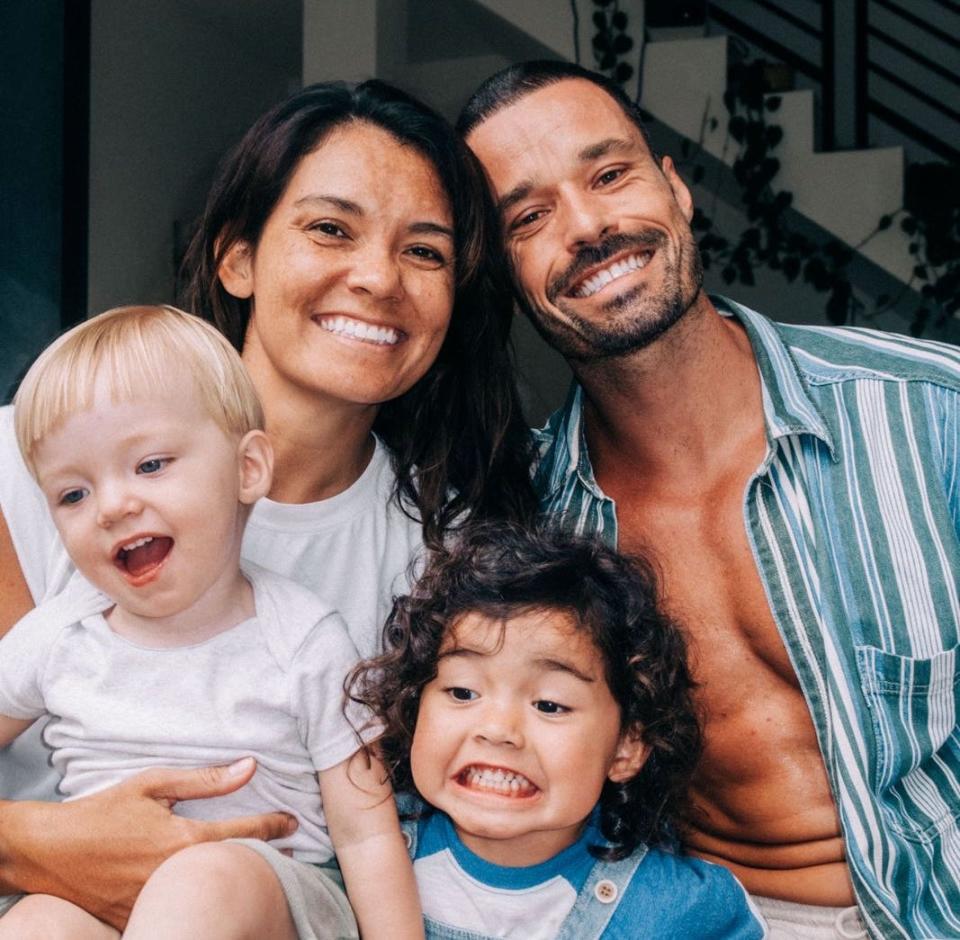 A man, woman, and two kids smiling for the camera.