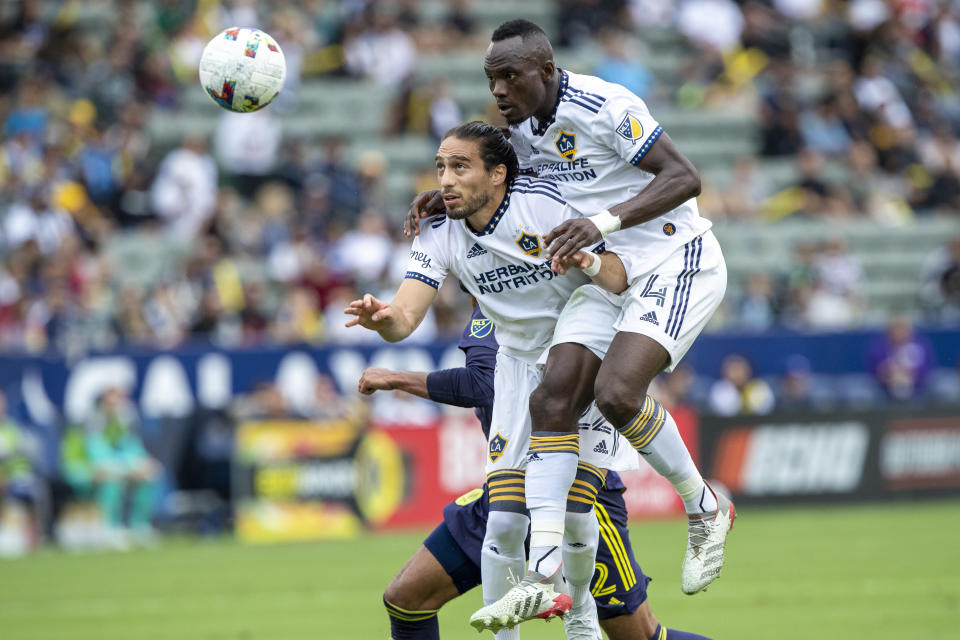 LA Galaxy defender Martin Caceres, left, and defender Sega Coulibaly, right, head the ball away from Nashville SC forward Teal Bunbury during the first half of an MLS playoff soccer match, in Carson, Calif., Saturday, Oct. 15, 2022. (AP Photo/Alex Gallardo)