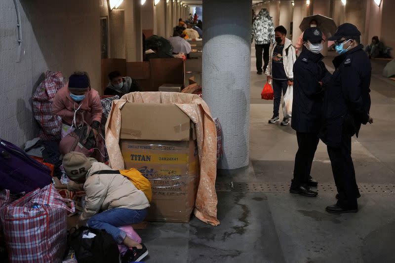 FILE PHOTO: Police officers disperse domestic workers gathering on their rest day, during the coronavirus disease (COVID-19) outbreak in Hong Kong, China