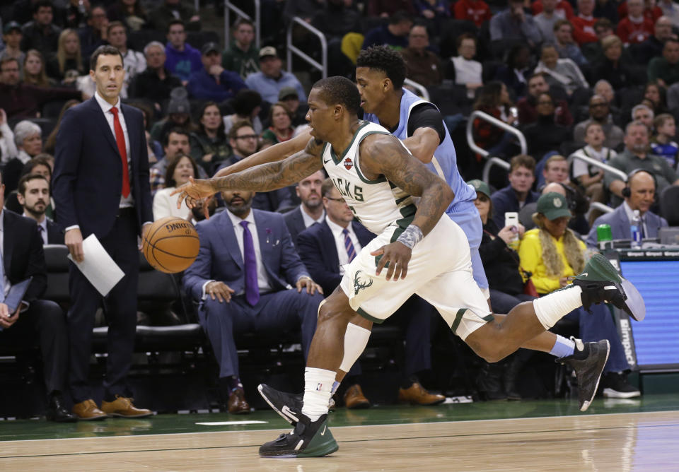 Milwaukee Bucks' Eric Bledsoe, front, and Minnesota Timberwolves' Jarrett Culver chase down a loose ball during the first half of an NBA basketball game Wednesday, Jan. 1, 2020, in Milwaukee. (AP Photo/Jeffrey Phelps)