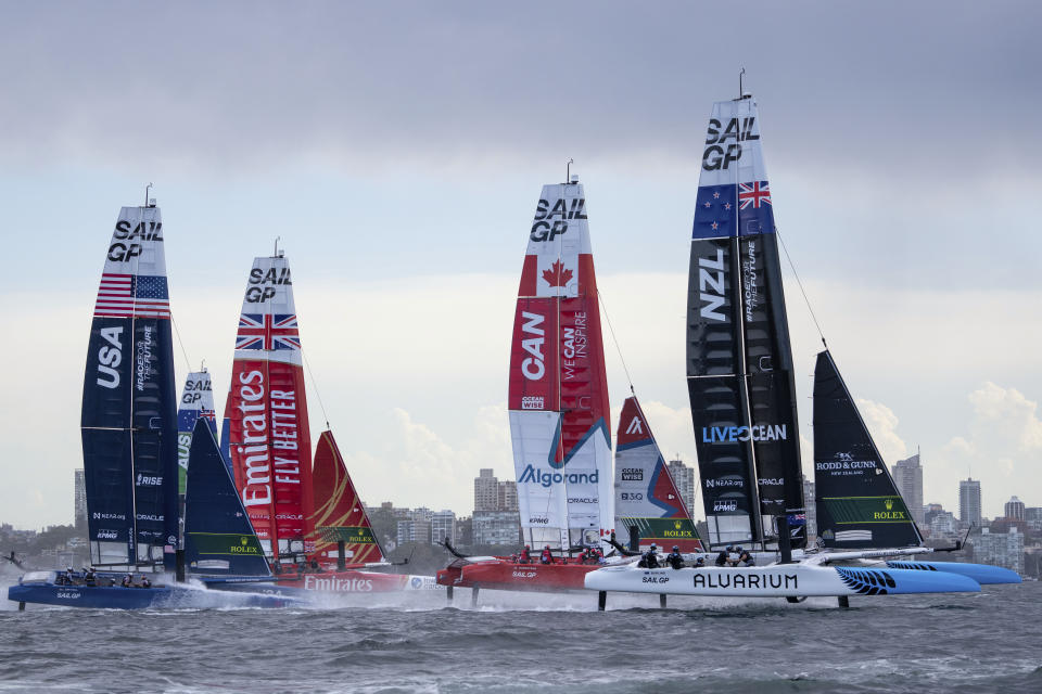 In this photo provided by SailGP, the fleet are led out by New Zealand during race 1 of the Australia Sail Grand Prix in Sydney, Australia, Saturday Feb. 18, 2023. (Bob Martin/SailGP via AP)
