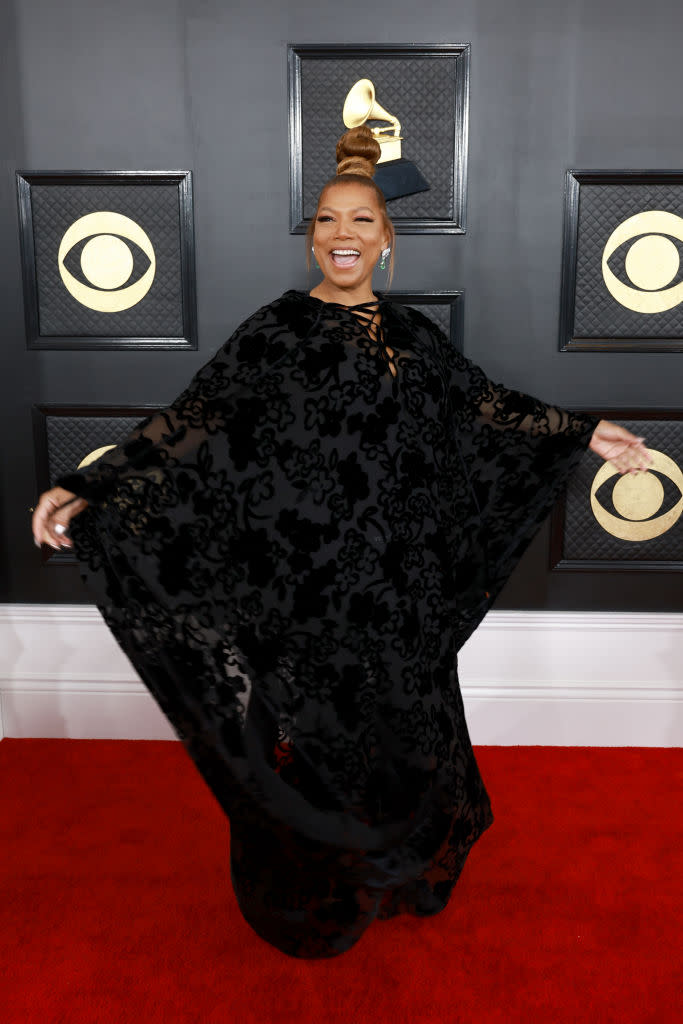 Queen Latifah in black mantilla dress with long-winged sleeves.