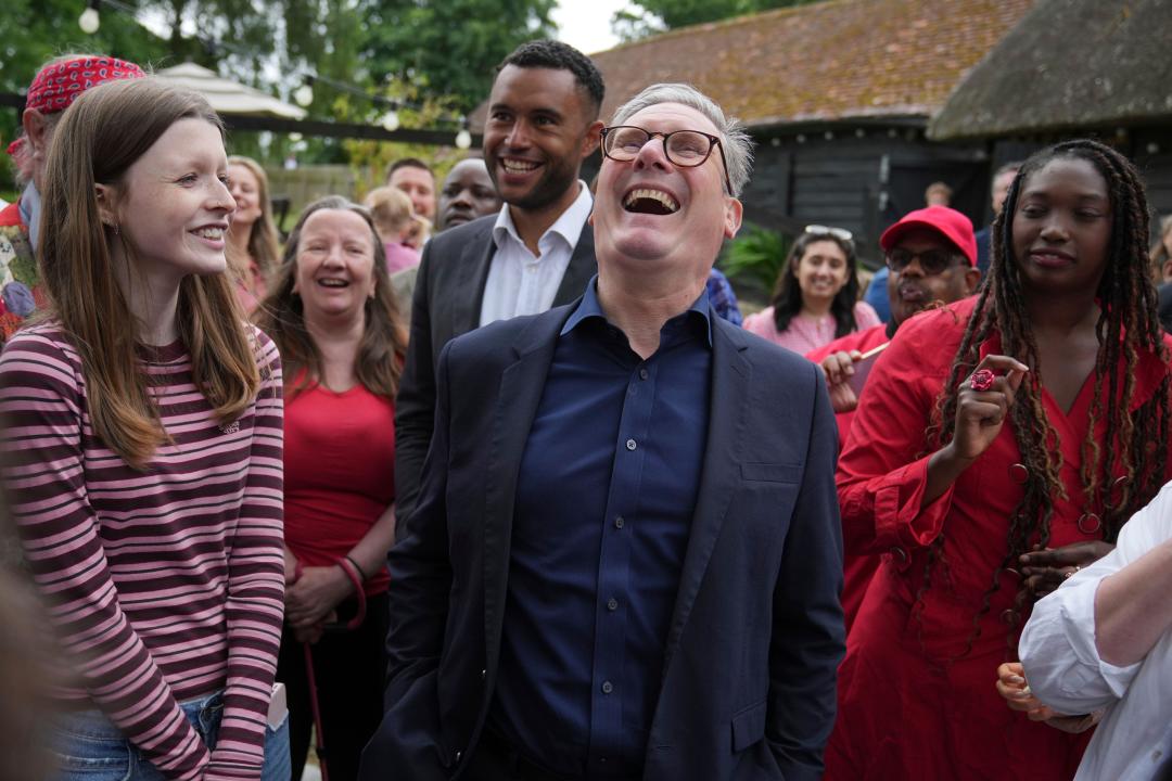 Britain's Labour Party leader Keir Starmer laughs as he speaks to supporters near Milton Keynes, England, Monday, July 1, 2024. Britain goes to the polls in a general election on July 4. (AP Photo/Kin Cheung)