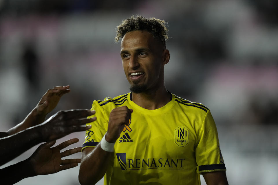 Teammates reach out to congratulate Nashville midfielder Hany Mukhtar after he scored the side's first goal against Inter Miami during the first half of an MLS soccer match, Wednesday, Sept. 22, 2021, in Fort Lauderdale, Fla. (AP Photo/Rebecca Blackwell)