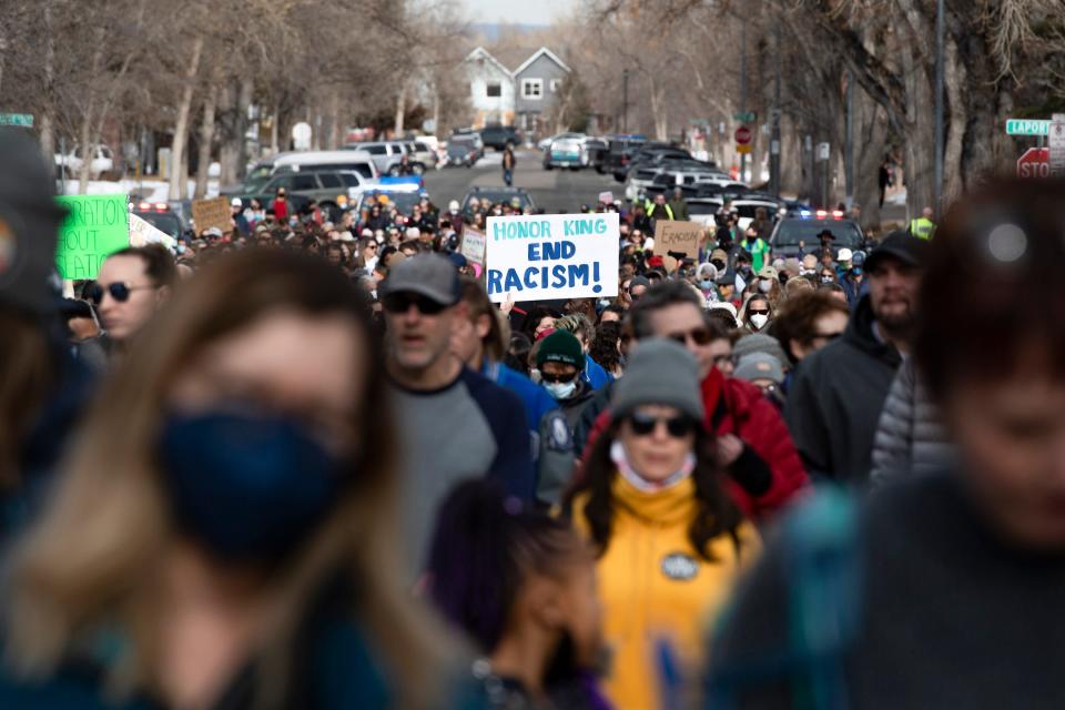 Participants in the Dr. Martin Luther King Jr. Day march walk toward Colorado State University campus, Monday, Jan. 17, 2022.