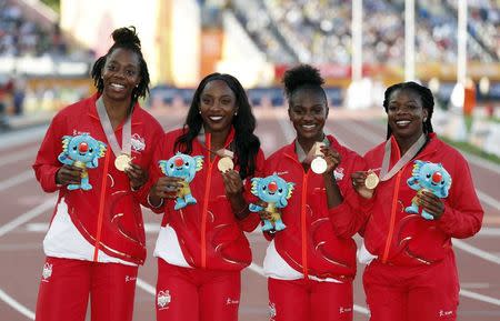 Athletics - Gold Coast 2018 Commonwealth Games - Women's 4x100m Relay - Medal Ceremony - Carrara Stadium - Gold Coast, Australia - April 14, 2018. Asha Philip, Dina Asher-Smith, Bianca Williams and Lorraine Ugen of England pose with their gold medals. REUTERS/Paul Childs