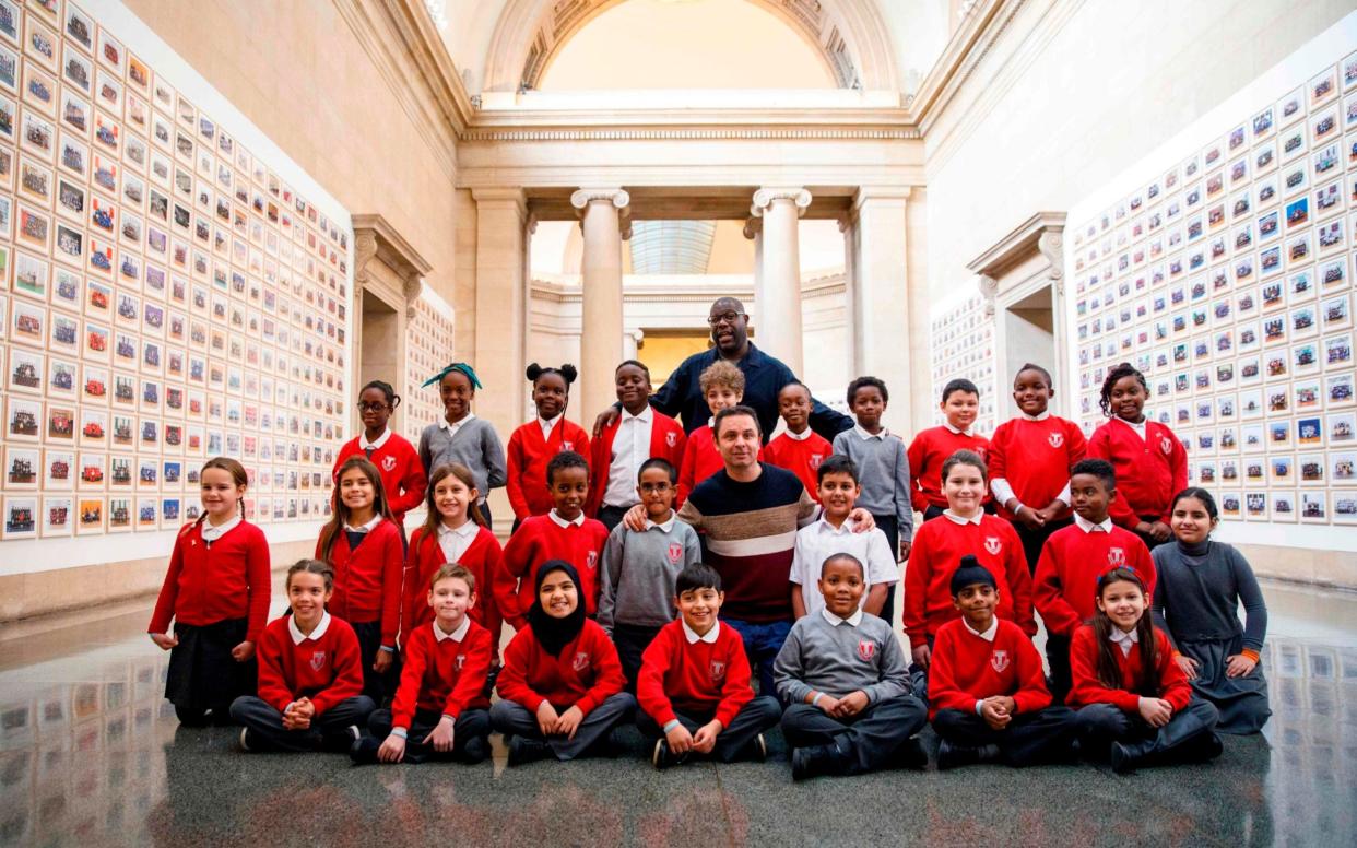 Steve McQueen at Tate Britain with pupils from Tyssen Community School  - AFP