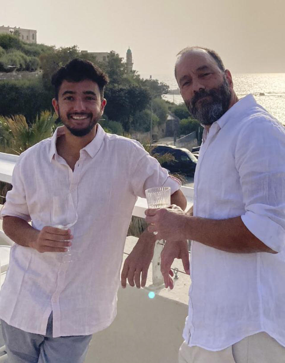 This undated photo provided by Rachel Goldberg shows her son Hersh Goldberg-Polin, left, with his father Jon Polin. The 23-year-old from Jerusalem was last seen when Hamas militants loaded him into the back of a pickup truck with other hostages abducted from a music festival in the western Negev Desert on Oct. 7. (Courtesy of Rachel Goldberg via AP)