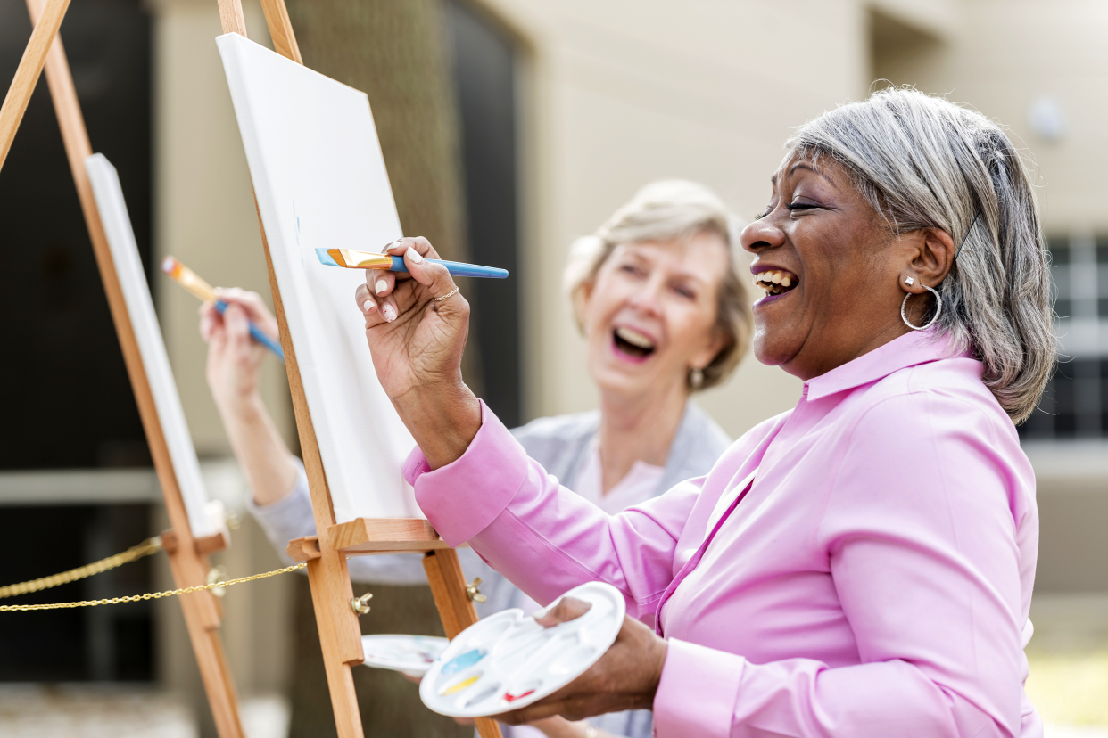 Senior women painting and laughing together