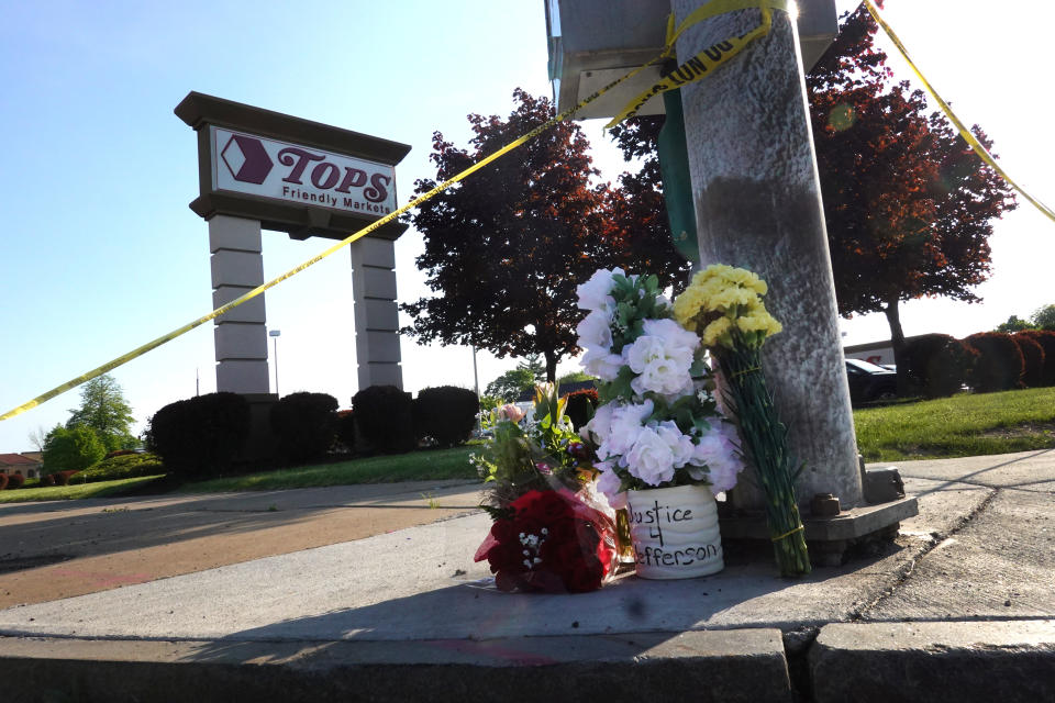 Flowers are left at a makeshift memorial outside of Tops market on May 15, 2022 in Buffalo, N.Y. Yesterday a gunman opened fire at the store, killing ten people and wounding another three. Suspect Payton Gendron was taken into custody and charged with first-degree murder. U.S. Attorney Merrick Garland released a statement, saying the US Department of Justice is investigating the shooting “as a hate crime and an act of racially-motivated violent extremism.” - Credit: Scott Olson/Getty Images