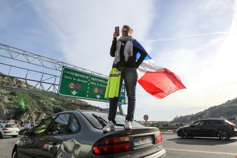 A protester stands on a car during a demonstration blocking traffic in Ventimiglia near the French-Italian border