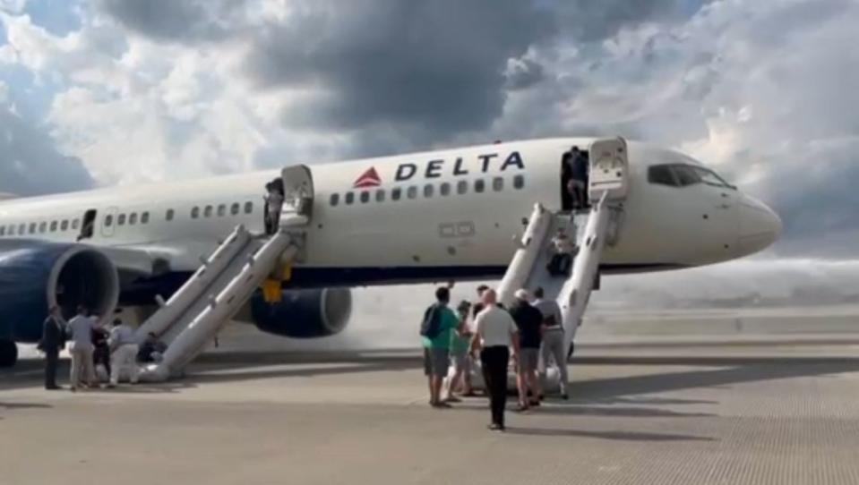 PHOTO: In this screen grab from a video, passengers on a Delta flight make an emergency evacuation at Hartsfield-Jackson Atlanta International Airport on Aug. 2, 2023. (Mike Russell)