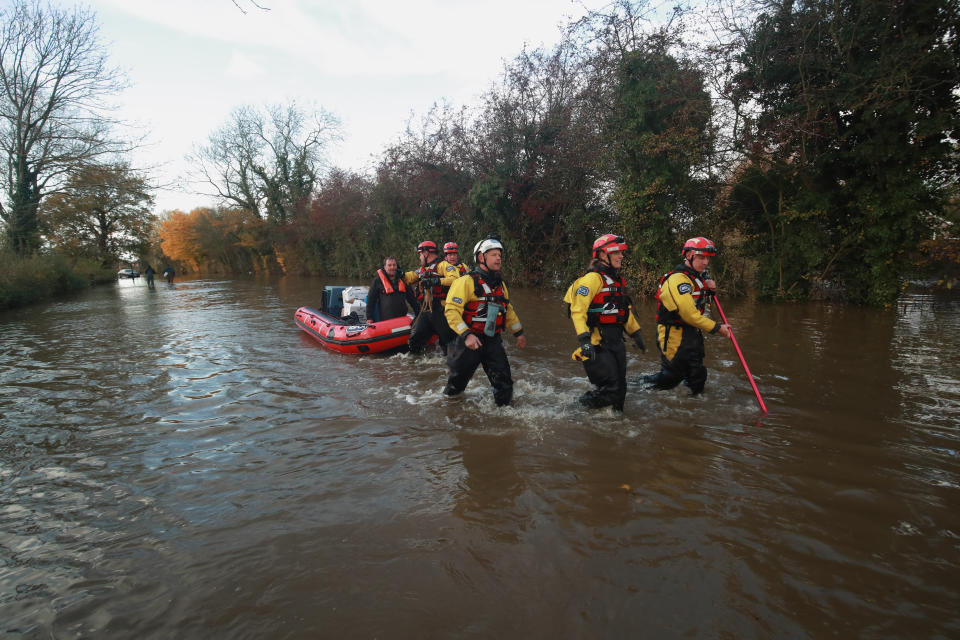 Rescuers pull a boat through floodwater in Fishlake, Doncaster. The Prime Minister is set to chair a meeting of the Government's emergency committee after severe flooding in parts of the country, where rain is finally expected to ease this afternoon.