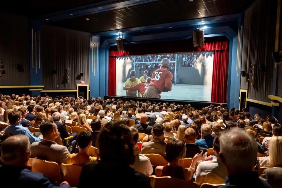 A VIP crowd watches the “12 Mighty Orphans” premiere June 7, 2021, in the restored New Isis theater in the Stockyards. (For a few moments, the house lights weren’t dimmed.)