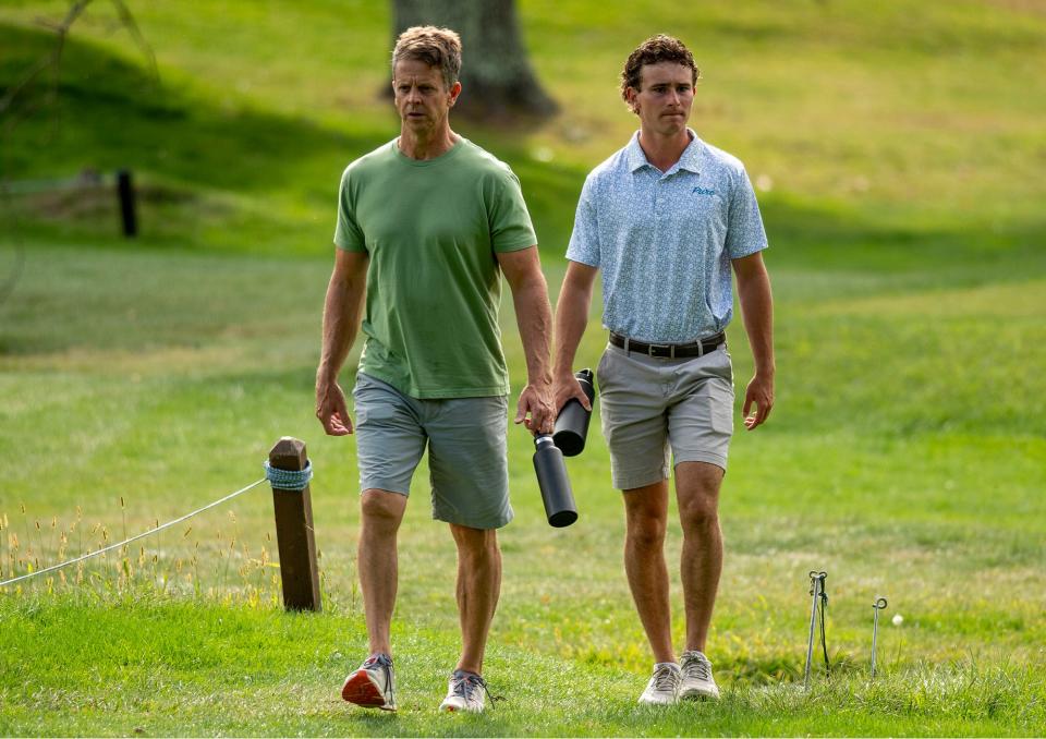 Kevin Fowler, left, and his oldest son Ian Fowler walk Maynard Golf Course on Thursday to watch Maynard High School senior Will Fowler during a match against Hudson.