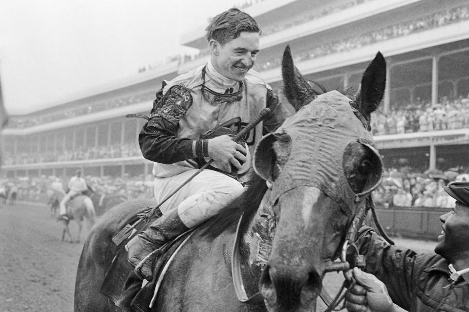 FILE - Jockey Bob Ussery sits atop Proud Clarion as they entered the winners circle after winning the Kentucky Derby horse race, May 6, 1967 in Louisville. Ussery, a Hall of Fame jockey who won the 1967 Kentucky Derby and then crossed the finish line first in the 1968 edition only to be disqualified days later, died Thursday, Nov. 16, 2023, of congestive heart failure at an assisted living facility in Hollywood, Fla., his son Robert told The Associated Press on Friday. He was 88. (AP Photo/File)