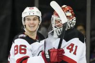 New Jersey Devils center Jack Hughes (86) and goaltender Vitek Vanecek (41) celebrate after closing the third period of an NHL hockey game against the New York Rangers, Monday, Nov. 28, 2022, in New York. (AP Photo/John Minchillo)