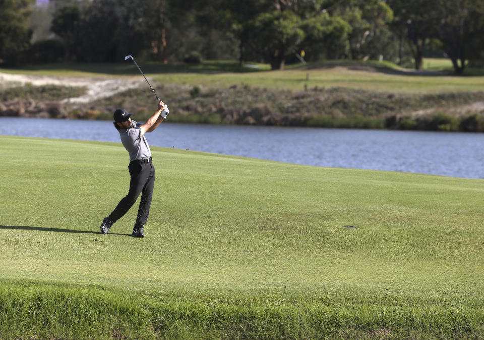 Abraham Ancer of Mexico hits his second shot on the 17th hole on his way to winning the Australian Open Golf tournament in Sydney, Sunday, Nov. 18, 2018. (AP Photo/Rick Rycroft)